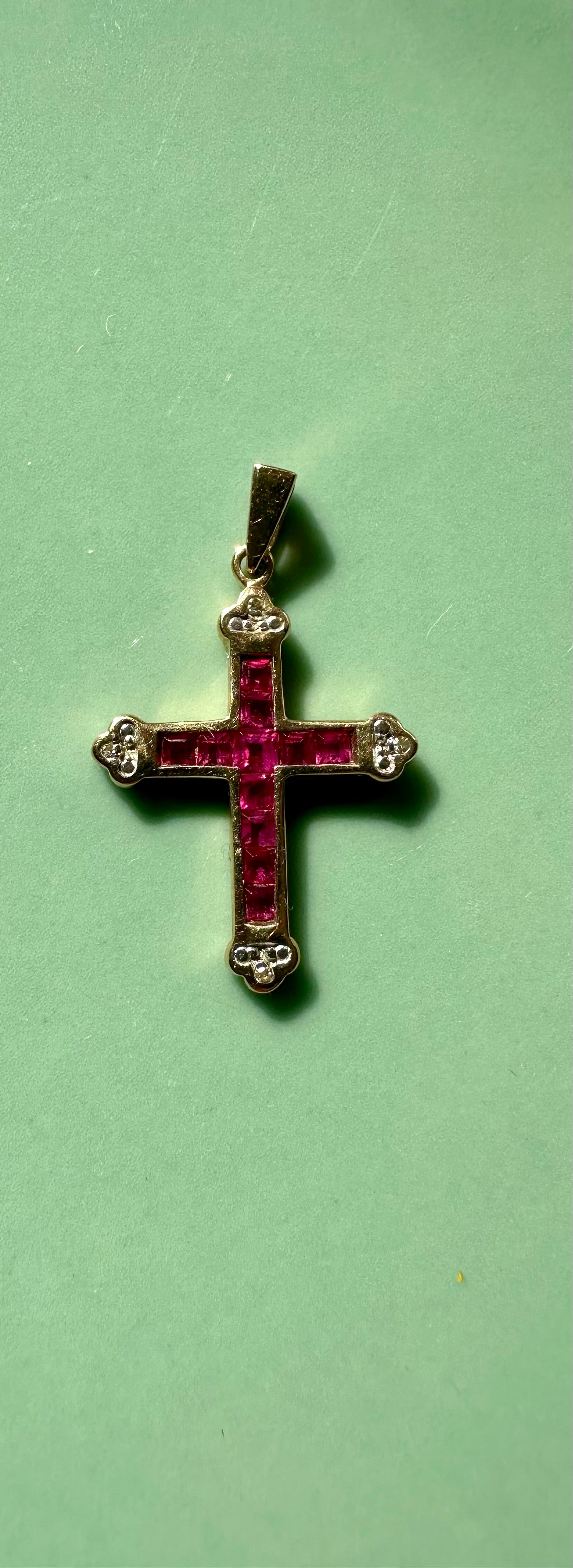 Small gold cross pendant set with rubies and diamonds